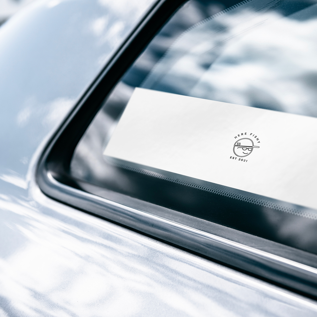 Here_Fishy_Bumper_Sticker_WhiteBumperSticker-CarWindow_Mockup.png_15756690